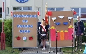 Na zdjęciu widać poczet sztandarowy i dekoracje uroczystości szkolnej  Pasowanie pierwszoklasist&oacute;w